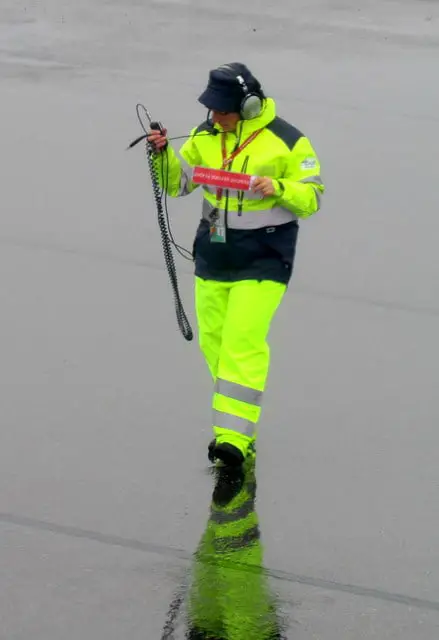 flight dispatcher wearing neon suit during work